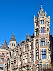 Obraz premium Historic architectural building featuring brick facade, ornate turrets, and medieval style details. Antwerp, Belgium