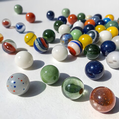 a set of marbles in various colors and sizes scattered on a white background