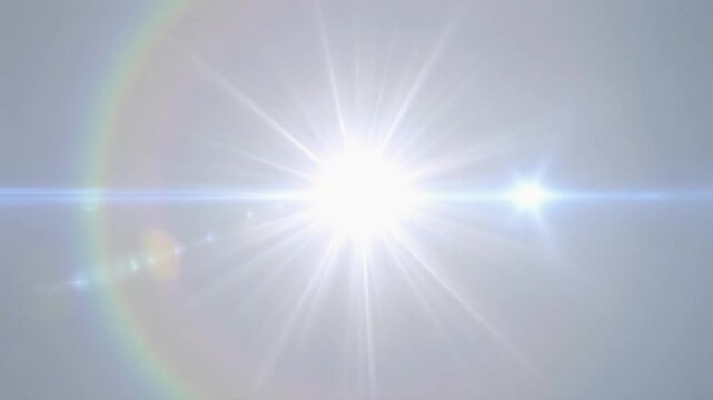 眩しい光のフレアが虹色に輝き移動する　光の輪ができる
