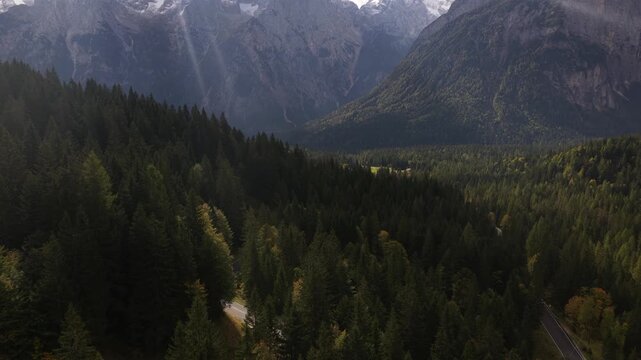 snowy peaks of mountain surrounding the Stelvio Pass, on the border between Switzerland and Italy. Aerial drone video. Beautifull driving serpentine roads over mountain pass.