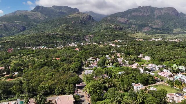 Breathtaking drone shot of Courtallam, Tamil Nadu &mdash; where misty mountains, green forests, and waterfalls create a serene blend of nature and town life.