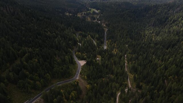 snowy peaks of mountain surrounding the Stelvio Pass, on the border between Switzerland and Italy. Aerial drone video. Beautifull driving serpentine roads over mountain pass.