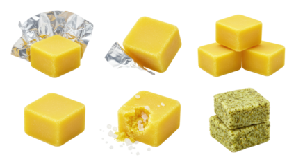 Assorted yellow bouillon or cheese cubes, some wrapped, one bitten plus green herb cake squares