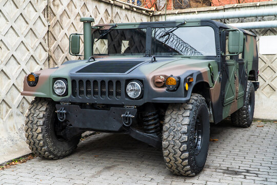 Military Humvee parked on an street, showcasing its rugged design and operational readiness in a secure military base. Khaki camouflage military Hummer front view. Army USA. 