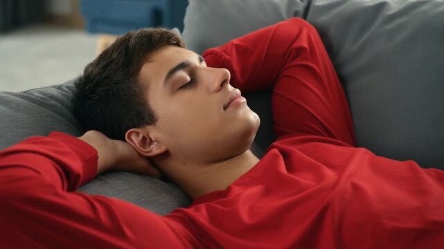 A young man sleeping on a cozy couch Stock Video