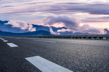 Empty asphalt highway road and mountain with beautiful sky clouds landscape at sunrise