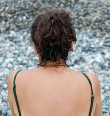 A woman with wet hair and a green top