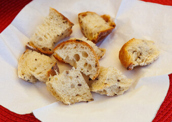 A plate of bread with a napkin underneath it