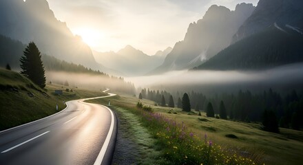 Golden light breaks through the morning mist, highlighting a beautiful winding road as it disappears into the grandeur of towering mountain peaks, inviting a serene journey