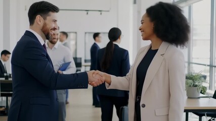 Dynamic business partnership handshake at modern office with diverse colleagues - Powered by Adobe