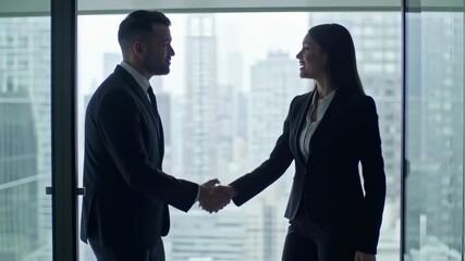 Successful business handshake between two corporate executives with cityscape background - Powered by Adobe