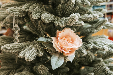 Frosted christmas tree with pink flower and glass ornament