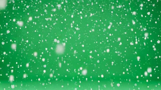 Realistic falling snow effect on a green screen background for chroma key compositing, a high-quality 4K winter video overlay