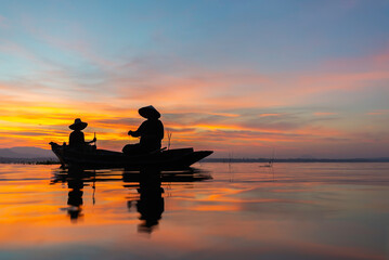 Fototapeta premium Fisherman ofLake in action when fishing