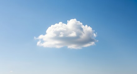 A single fluffy white cloud floating in a clear blue sky during daytime with no visible landmarks or other objects