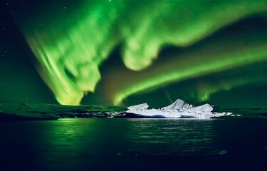 Spectacular green aurora borealis dancing across starry night sky, illuminating jagged icebergs floating in calm dark water. Ethereal glow reflects on the surface, creating a magical polar scene.