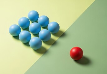 Unique red ball standing out from blue balls on green yellow background