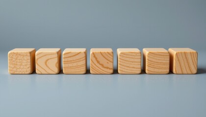 Close-up View of Blank Wooden Blocks Stacked in a Row Against a Soft Blue Background for Creative Projects