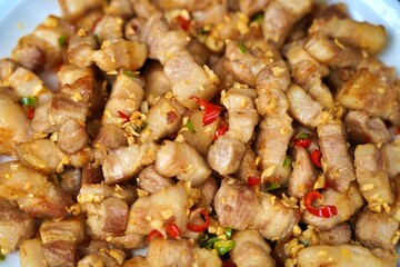 Close-up of crispy pork belly stir-fried with chili and salt – spicy Thai street food in vivid detail
