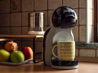 Setting with latte machine and fresh fruit in the background