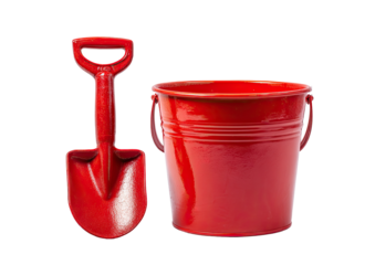 A bright red bucket and matching shovel sit against a stark black background, isolated