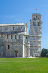 The famous Leaning Tower of Pisa with copy space on the lawn. Vertically. Italy.