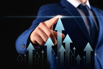 Businessman pointing at a group of glowing arrows symbolizing business growth, financial success, market increase, and upward performance trend.