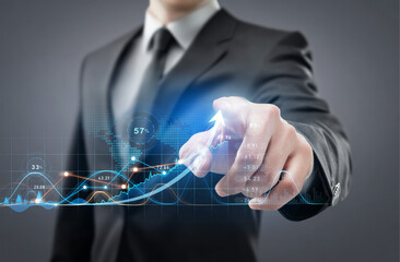 Businessman touching a glowing line graph overlaying a bar chart, symbolizing financial growth, excellent business performance, and rising market success.