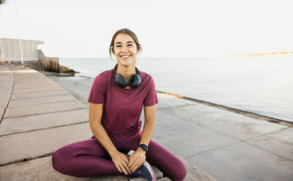 Young woman smiling enjoying outdoor fitness moment