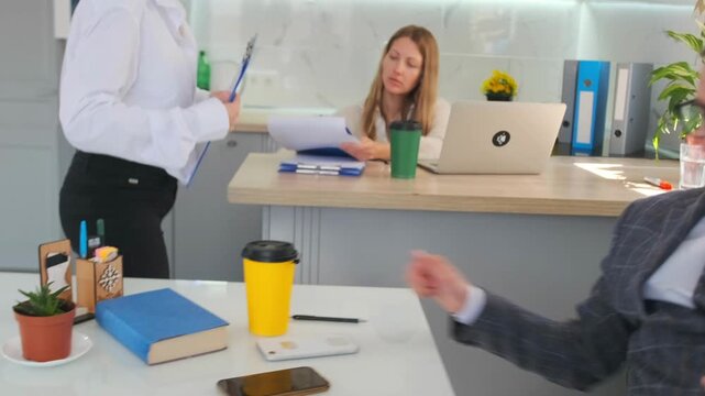 executive signing paperwork, relaxed office scene with documentation, corporate executive casually signing documents at desk, white executive calmly signing paperwork in relaxed office environment