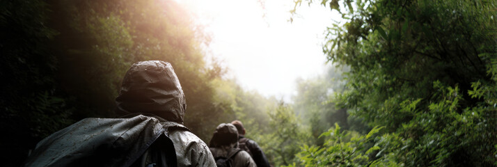 Hiking forest rain backpack trail Adventurous trek misty canopy with wet gear and soft light