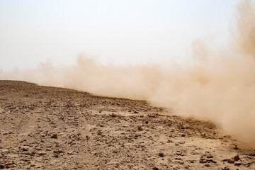 Zikreet, Qatar - November 15, 2025: A large storm formed, powdered dust and sand on the ground were blown into the clouds, causing the orange glow to look horrible. extreme weather events.