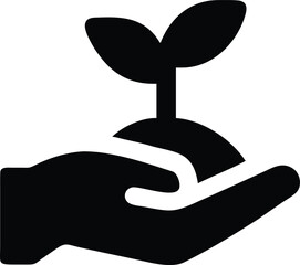 A gentle hand delicately holds a young plant sprouting from a mound