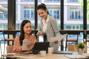 A young business team is working on a business report document on the office desk. Brainstorming Business People Design Planning, Brainstorming Planning Partnership.