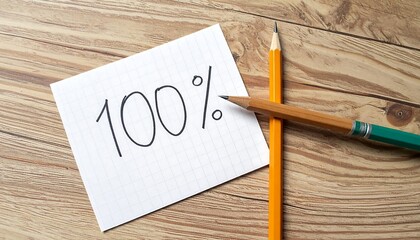 100 Percent Concept on Paper with Pencils on Wooden Table.