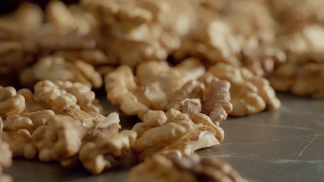 Close-up shots of walnut kernels highlight their rich texture and color. Enjoy these nuts as a healthy snack that boosts energy and provides beneficial fats.