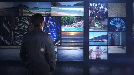 Business man choosing future path from video wall - Powered by Adobe