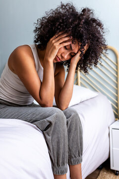 Woman experiencing headache and stress feeling pain in bedroom