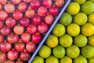 Lime (fruit),  green orange fruit, pomegranate fruit, Pomegranate fruit on a tree in a pomegranate garden. Selective focus, shallow depth.