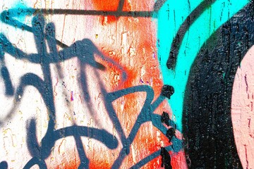 Urban graffiti art featuring vibrant splashes of orange, blue, black. 90s grunge vibe, textured surfaces, bold strokes. Street art, posters, urban culture, modern 90s, Y2K visuals.