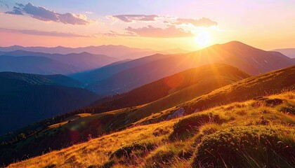 A breathtaking sunrise illuminates a vast mountain landscape, with layers of peaks fading into the distance and golden light bathing the foreground.