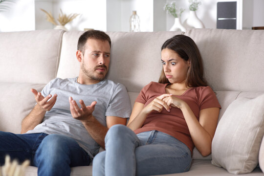 Stunned woman listening her partner at home