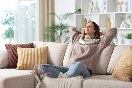Woman in brown relaxing in winter at home