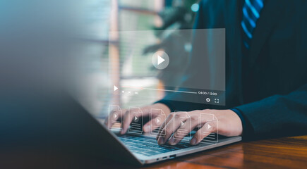 A digital video interface floating above a laptop as hands type, representing online media creation, streaming technology, content management, and modern workflow for professional video production.