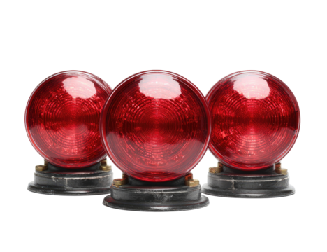 Three red, translucent orbs on gray bases, presented against a stark black background