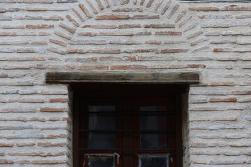 Old Red Brick House with Arched Window