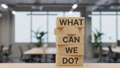 WHAT CAN WE DO? text on wooden blocks in a modern office, symbolizing business problem-solving and strategy.
