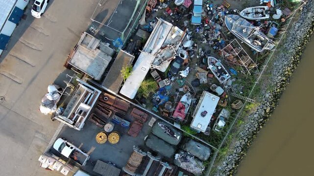 Aerial view of marina garbage stock pile as drone fly over.