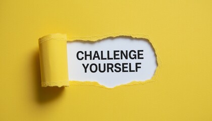 Torn yellow paper revealing CHALLENGE YOURSELF motivational text, symbolizing personal growth and new opportunities.