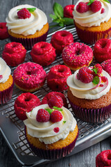 A delicious layered cake is topped with fresh raspberries and blackberries, showing vibrant colors and contrasting textures.